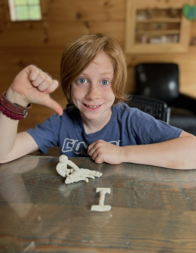 Hands creating clay art during a multisensory tutoring activity